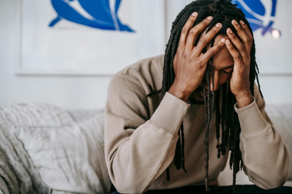 man experiencing gambling addiction and anxiety sitting alone